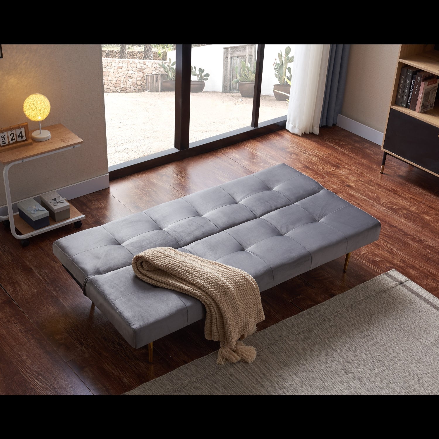 estelle sleeper sofa set in a study with pillows and a blanket on it