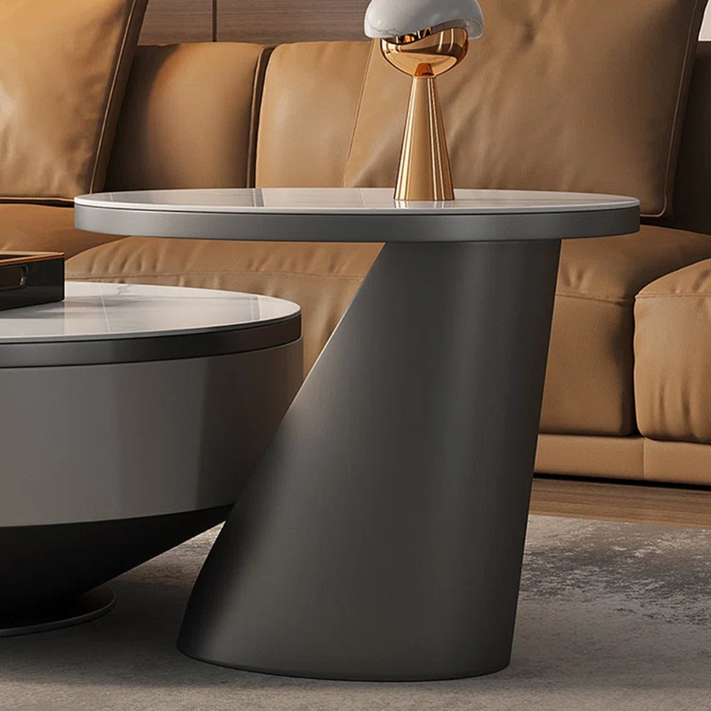 A modern coffee table with a round top and base, part of the Aspen Grey Coffee &amp; End Table Set.